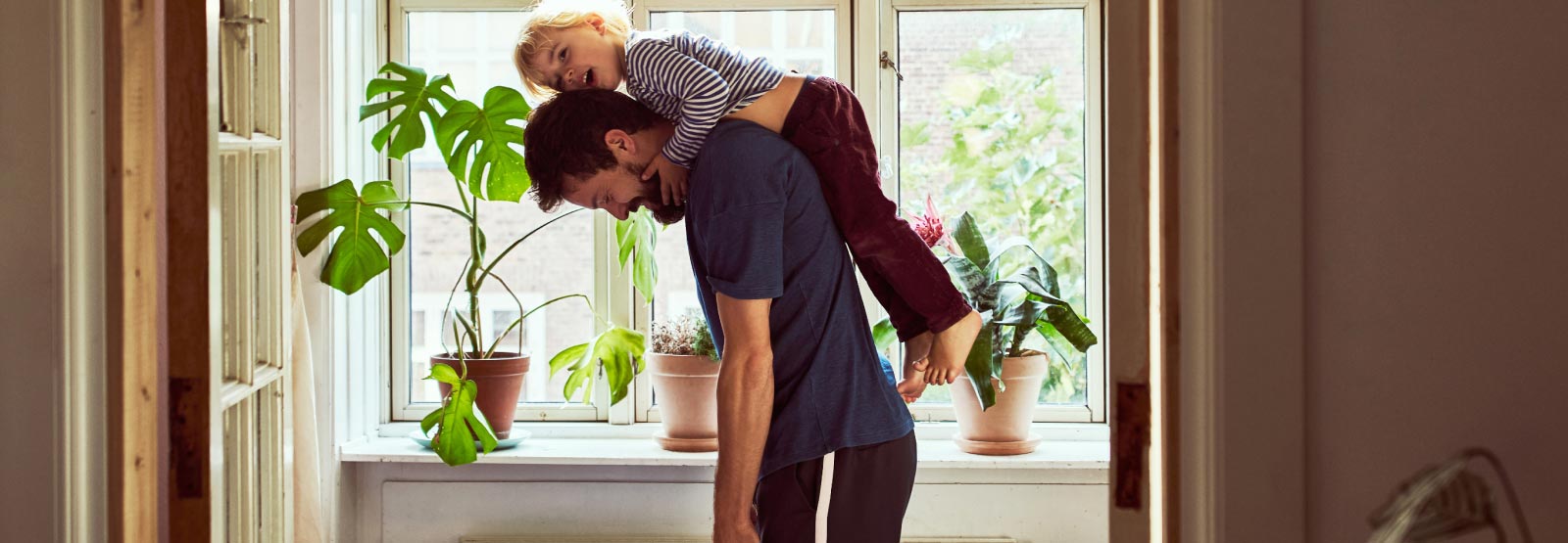 Father and kid on back at home.