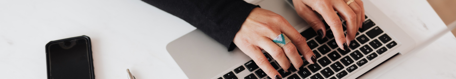 Hands with a ring typing on a keyboard